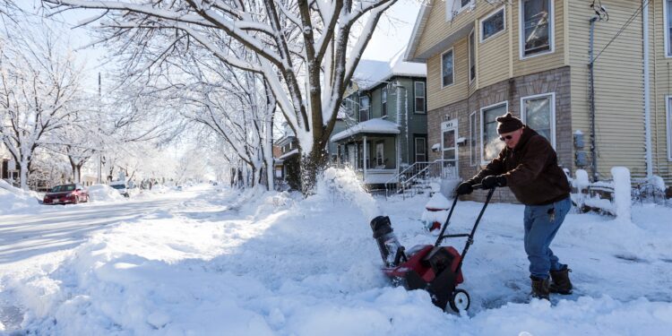 MADISON, WISCONSIN - DECEMBER 21: Dave Anderson uses a snow blower to clean the sidewalk December 21, 2012 in Madison, Wisconsin. A day after a record snow storm hit Wisconsin, schools were closed Thursday and Friday. (Photo by Andy Manis/Getty Images)