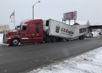 Potato truck crushed after drive under bridge