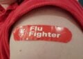 Person's bicep with sleeve rolled up and adhesive bandage with Walgreens logo and text reading Flu Fighter, Lafayette, California, December 8, 2021. (Photo by Smith Collection/Gado/Getty Images)