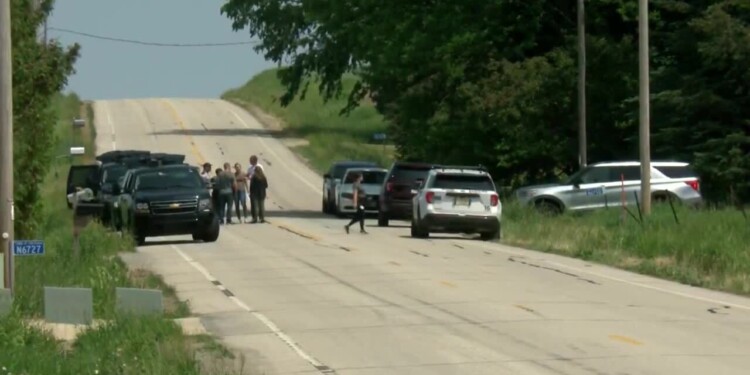 Investigators on County Highway E after an officer-involved shooting