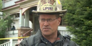 Fire Chief Aaron Lipski outside the house where a firefighter fell through the floor at 29th and Scott