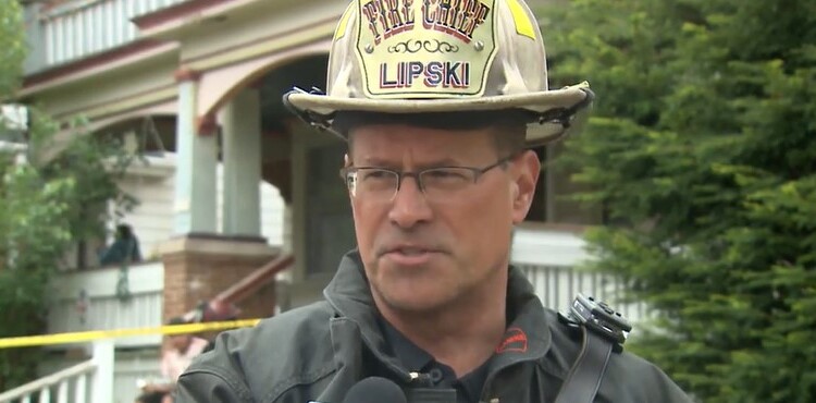 Fire Chief Aaron Lipski outside the house where a firefighter fell through the floor at 29th and Scott