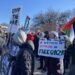 Protestors gather with Palestinian flags and signs saying "Free Gaza" and "Stop the war"