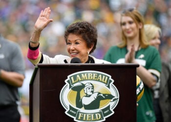 GREEN BAY, WISCONSIN - SEPTEMBER 15: Cherry Louise Morton, wife of the late Bart Starr, waves to the crowd during a ceremony for Starr at halftime of the game between the Minnesota Vikings and Green Bay Packers at Lambeau Field on September 15, 2019 in Green Bay, Wisconsin. (Photo by Quinn Harris/Getty Images)