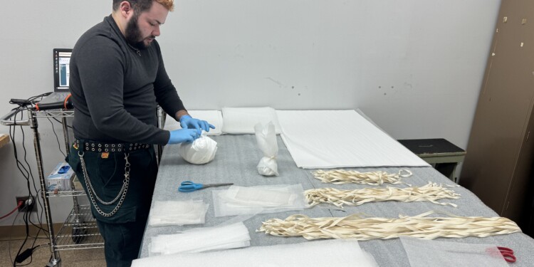 Photo of Employee Quin Tahon wrapping up ceramics for the big mvoe