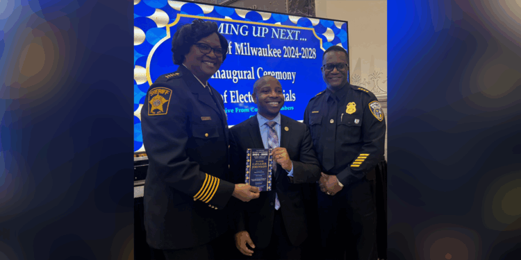 Mayor Johnson taking a picture at his inauguration with Police Chief Jeffrey Norman and Sheriff Denita Ball