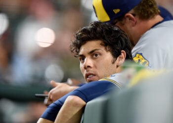 BALTIMORE, MARYLAND - APRIL 13: Christian Yelich #22 of the Milwaukee Brewers watches the game in the seventh inning against the Baltimore Oriolesat Oriole Park at Camden Yards on April 13, 2022 in Baltimore, Maryland. (Photo by Greg Fiume/Getty Images)