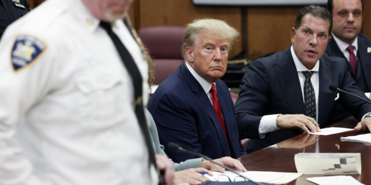 Former U.S. President Donald Trump sits in the courtroom with his attorneys Joe Tacopina and Boris Epshteyn (R) during his arraignment at the Manhattan Criminal Court April 4, 2023 in New York City. Trump pleaded not guilty to 34 felony counts stemming from hush money payments made to adult film star Stormy Daniels before the 2016 presidential election and making false statements to cover up other crimes.