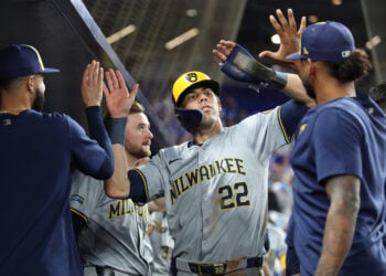 MIAMI, FL - MAY 21: Milwaukee Brewers outfielder Christian Yelich (22) gets high fives in the dugout after scoring a run in the eighth inning during the game between the Milwaukee Brewers and the Miami Marlins on Tuesday, May 21, 2024 at LoanDepot Park in Miami, Fla. (Photo by Peter Joneleit/Icon Sportswire via Getty Images)