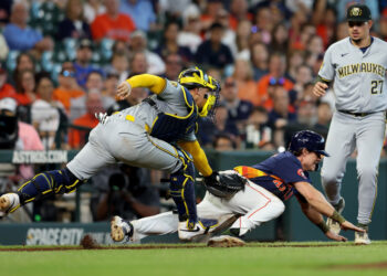 HOUSTON, TEXAS - MAY 19: William Contreras #24 of the Milwaukee Brewers tags Jake Meyers #6 of the Houston Astros out in the seventh inning at Minute Maid Park on May 19, 2024 in Houston, Texas. (Photo by Tim Warner/Getty Images)