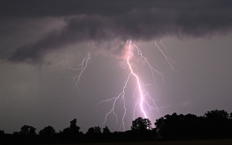Lightning strikes over the countryside during a thunderstorm following high temperatures on July 10, 2024 near Potsdam, eastern Germany. (Photo by RALF HIRSCHBERGER / AFP) (Photo by RALF HIRSCHBERGER/AFP via Getty Images)