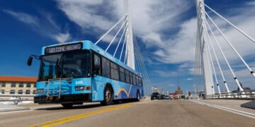 A Milwaukee County Transit System bus drives on 6th Street in Milwaukee. Image Credit: Milwaukee County Transit System
