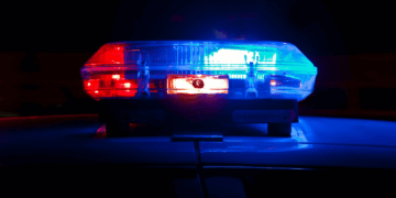 Police lights. Photo by Scott Rodgerson on Unsplash.