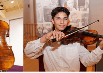 Latino Arts Strings Program student Hector Hernandez with a klezmer violin from Violins of Hope. Photo courtesy of Latino Arts