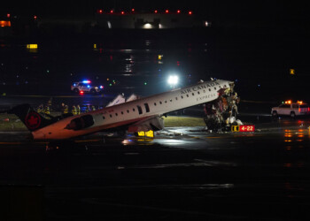 An Air Canada Jet sits on the runway at LaGuardia Airport, Monday, March 23, 2026, after colliding with a Port Authority aircraft rescue and firefighting vehicle in New York. (AP Photo/Ryan Murphy)