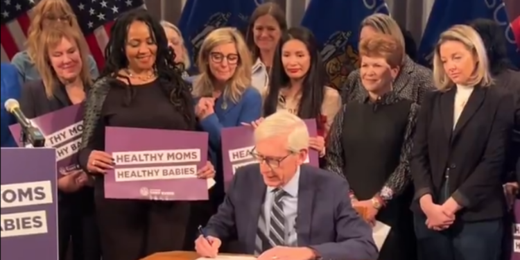 Governor Tony Evers signed a bill Wednesday, March 18 at Children's Wisconsin in Milwaukee that expands postpartum Medicaid coverage for new moms.
