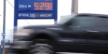 A vehicle passes a gasoline price board at a filling station in Philadelphia, Friday, March 27, 2026. (AP Photo/Matt Rourke)