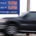 A vehicle passes a gasoline price board at a filling station in Philadelphia, Friday, March 27, 2026. (AP Photo/Matt Rourke)