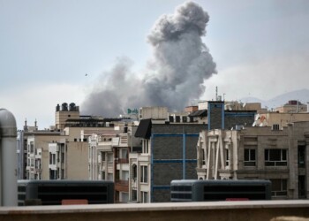 A plume of smoke rises after a strike in Tehran, Iran, Tuesday, March 2, 2026. (AP Photo/Vahid Salemi)