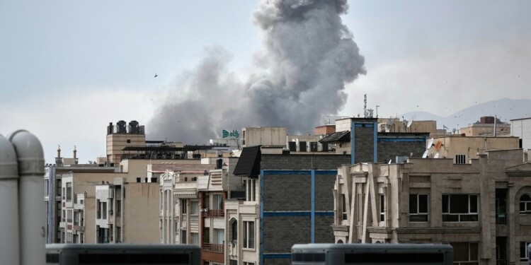 A plume of smoke rises after a strike in Tehran, Iran, Tuesday, March 2, 2026. (AP Photo/Vahid Salemi)