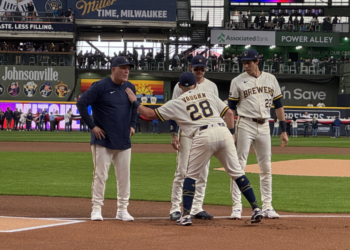 Andrew Vaughn taps Manager Pat Murphy on the shoulder on Opening Day 2026