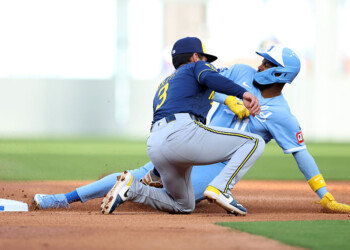KANSAS CITY, MISSOURI - APRIL 04: Third baseman Maikel Garcia #11 of the Kansas City Royals is tagged out while stealing by shortstop Joey Ortiz #3 of the Milwaukee Brewers during the 1st inning of game two of a double-header at Kauffman Stadium on April 04, 2026 in Kansas City, Missouri. (Photo by Jamie Squire/Getty Images)