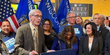Governor Tony Evers takes action on Assembly Bill 759 during a bill signing ceremony Thursday in Milwaukee. (Neil Doyle/WTMJ)