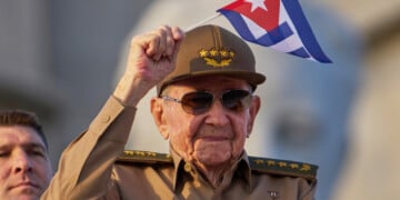 FILE - Raul Castro waves a Cuban national flag during a May Day parade at Revolution Square in Havana on May 1, 2025. (AP Photo/Ramon Espinosa, File)