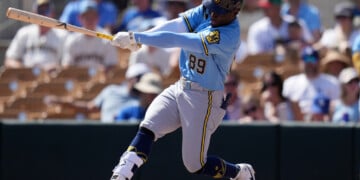 FILE - Milwaukee Brewers' Luis Lara follows through with his swing against the Los Angeles Dodgers during the third inning of a spring training baseball game, Monday, March 16, 2026, in Phoenix. (AP Photo/Ross D. Franklin,File)