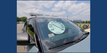Car windshield with thermometer showing 120 degrees on dashboard.