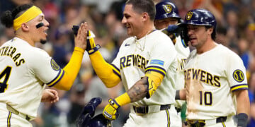 Joey Ortiz celebrates with teammates after hitting a home run.