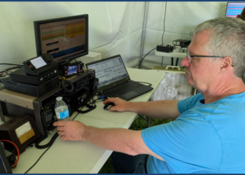 Dave Schank sits at a Ham radio setup for ARRL Field Day
