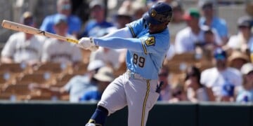 Milwaukee Brewers' Luis Lara follows through with his swing against the Los Angeles Dodgers during the third inning of a spring training baseball game, Monday, March 16, 2026, in Phoenix. (AP Photo/Ross D. Franklin,File)