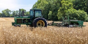 June 7, 2024- Menokin, Virginia: A John Deere farm tractor harvests golden barley in a field. (Getty Images)