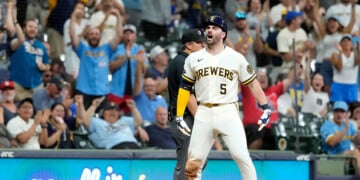 Garrett Mitchell celebrates a go-ahead triple at American Family FIeld.