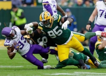 FILE - Minnesota Vikings running back Aaron Jones Sr. (33) is hit by Green Bay Packers defensive tackle Devonte Wyatt (95) during an NFL football game between the Green Bay Packers and Minnesota Vikings Nov. 23, 2025, in Green Bay, Wis. (AP Photo/Matt Ludtke, File)