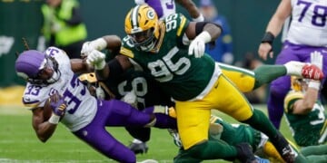 FILE - Minnesota Vikings running back Aaron Jones Sr. (33) is hit by Green Bay Packers defensive tackle Devonte Wyatt (95) during an NFL football game between the Green Bay Packers and Minnesota Vikings Nov. 23, 2025, in Green Bay, Wis. (AP Photo/Matt Ludtke, File)