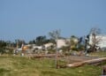 Debris and fallen trees cover the ground after a tornado struck the day before, Tuesday, July 28, 2026, in Appleton, Wis. (AP Photo/Kayla Wolf)
