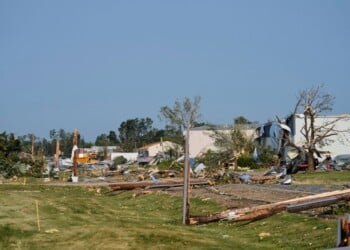 Debris and fallen trees cover the ground after a tornado struck the day before, Tuesday, July 28, 2026, in Appleton, Wis. (AP Photo/Kayla Wolf)