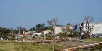 Debris and fallen trees cover the ground after a tornado struck the day before, Tuesday, July 28, 2026, in Appleton, Wis. (AP Photo/Kayla Wolf)