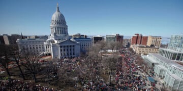 FILE - Protestors, and supporters, of Wisconsin Gov. Scott Walker's bill to eliminate collective bargaining rights for many state workers gather outside the state Capitol in Madison, Wis. on Feb. 19, 2011. (AP Photo/Andy Manis, File)