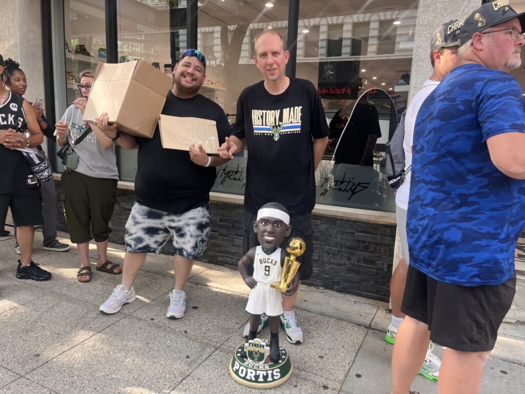 Will Lindquiast (left) and Tony Sergio (right) holding bobbleheads.