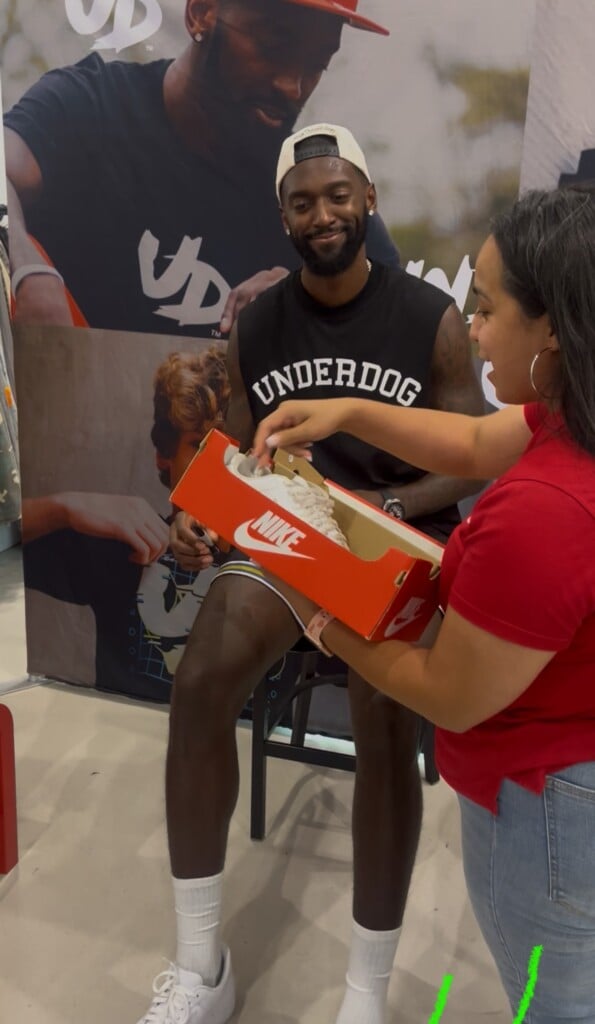 Bobby Portis Jr. signing Diana Martinez's shoes.