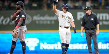 Andrew Vaughn points to the dugout after hitting a game-winning hit in the 8th inning at American Family Field.