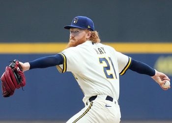 Dustin May throws a pitch at American Family Field.