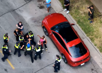 Drone video shows a struggle between Madison officers and the city's independent police monitor. Image courtesy of Madison Police Department