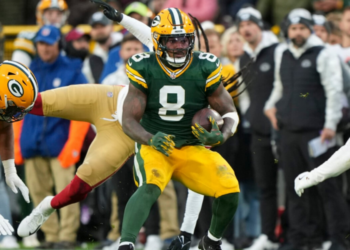 GREEN BAY, WISCONSIN - NOVEMBER 24: Running back Josh Jacobs #8 of the Green Bay Packers runs the ball during the first half of an NFL football game against the San Francisco 49ers at Lambeau Field on November 24, 2024 in Green Bay, Wisconsin. (Photo by Todd Rosenberg/Getty Images)