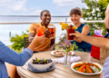 Friends Cheers Over Food In Downtown Bayfield (Photo: Travel Wisconsin)