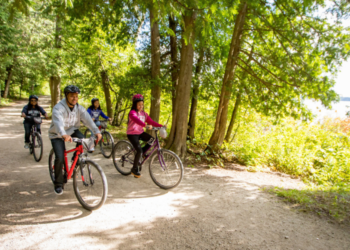 Family biking on a trail in Peninsula State Park
