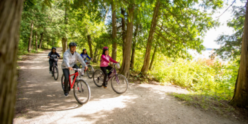 Family biking on a trail in Peninsula State Park